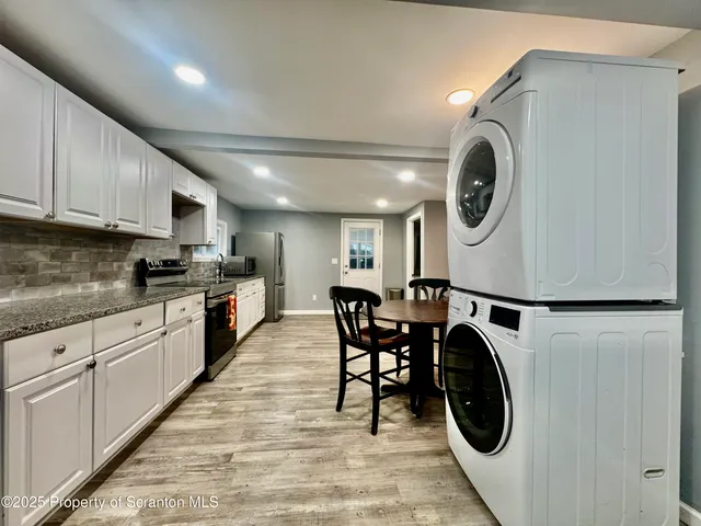 a kitchen with a white stove top oven and cabinets