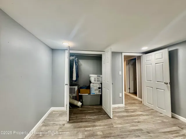 a view of a hallway with a livingroom and furniture