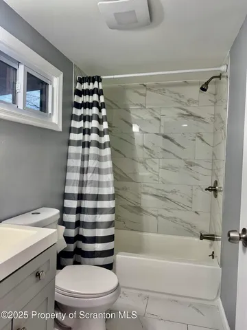 a bathroom with a bathtub and a toilet