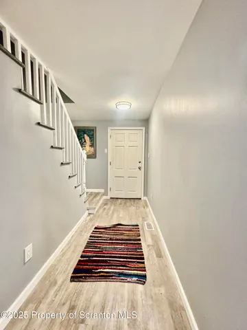 a spacious bedroom with a bed and wooden floor