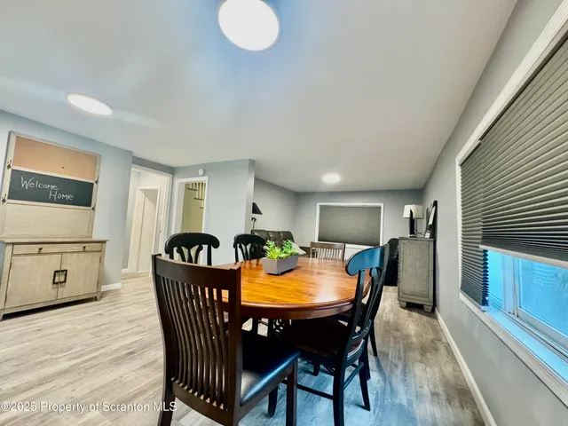 a view of a dining room with furniture and a kitchen