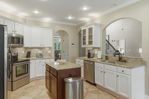 a kitchen with a sink stove and refrigerator