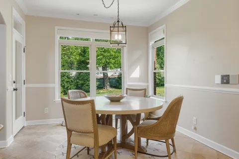 a dining room with furniture window and wooden floor