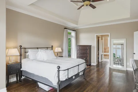 a bedroom with a bed and a chandelier