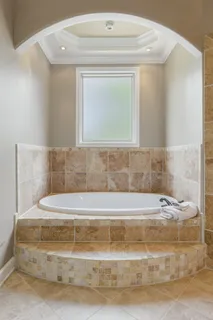 a bathroom with a granite countertop sink a toilet and bathtub