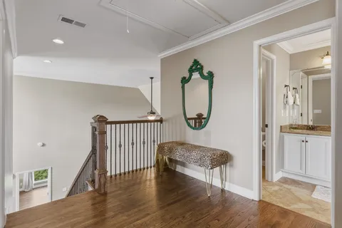a living room with furniture and a baby crib