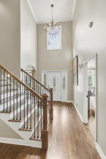 a view of entryway and hall with wooden floor