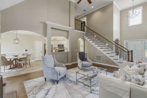 a living room with furniture and a dining table