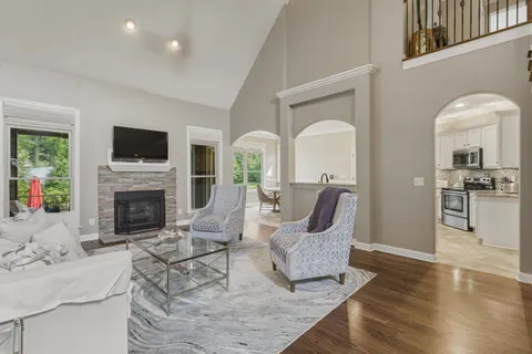 a living room with furniture a fireplace and a flat screen tv