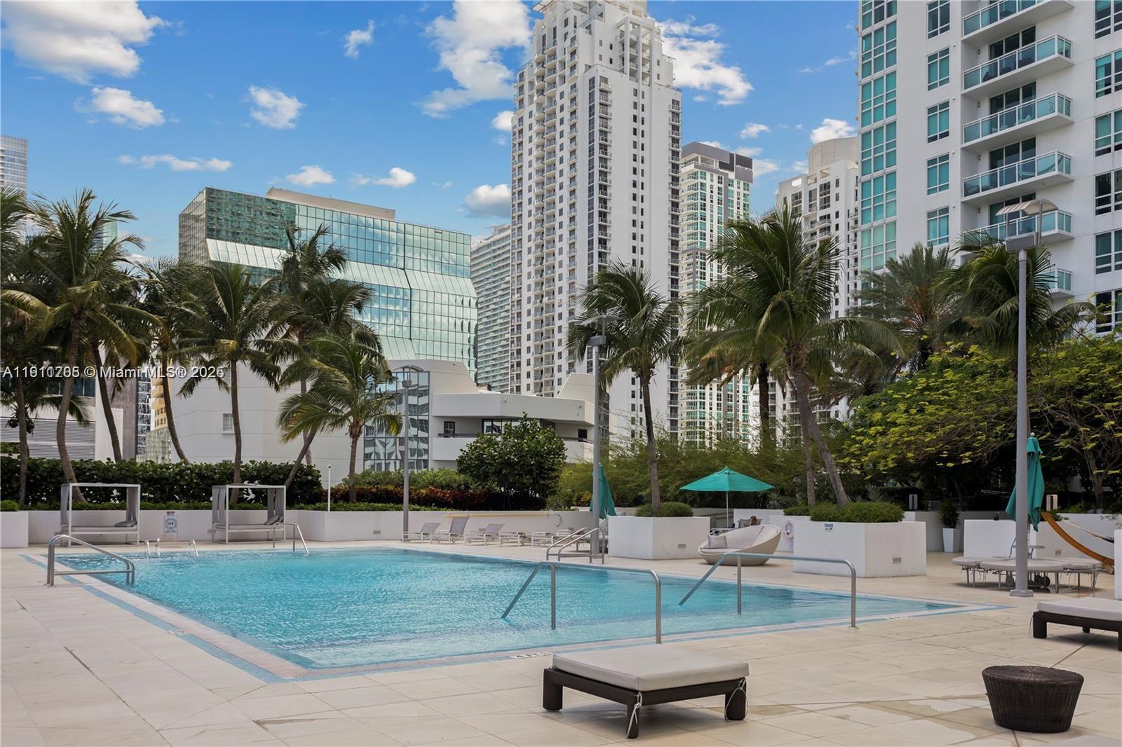 951 Brickell Avenue, Unit 2601 Miami, FL 33131 - Photo 13 of 21 a building with swimming pool and outdoor seating