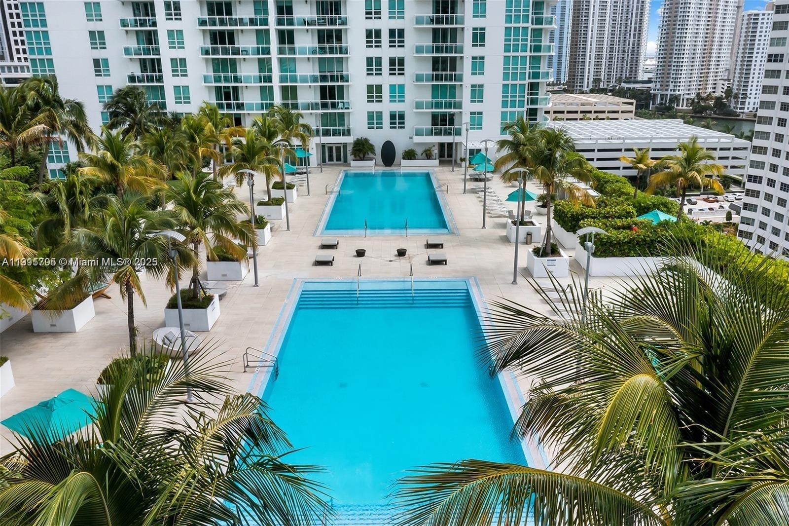 951 Brickell Avenue, Unit 2601 Miami, FL 33131 - Photo 19 of 21 a view of a swimming pool with a garden