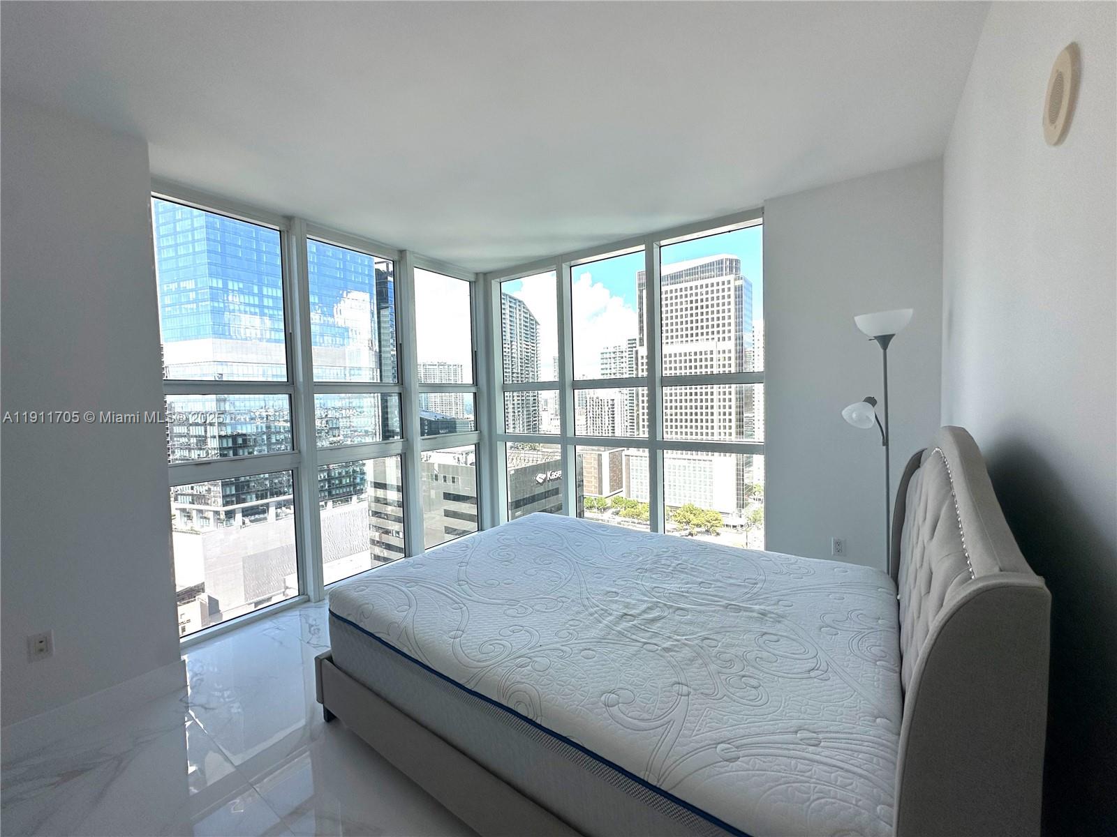 951 Brickell Avenue, Unit 2601 Miami, FL 33131 - Photo 6 of 21 a bedroom with a large bed and a large window