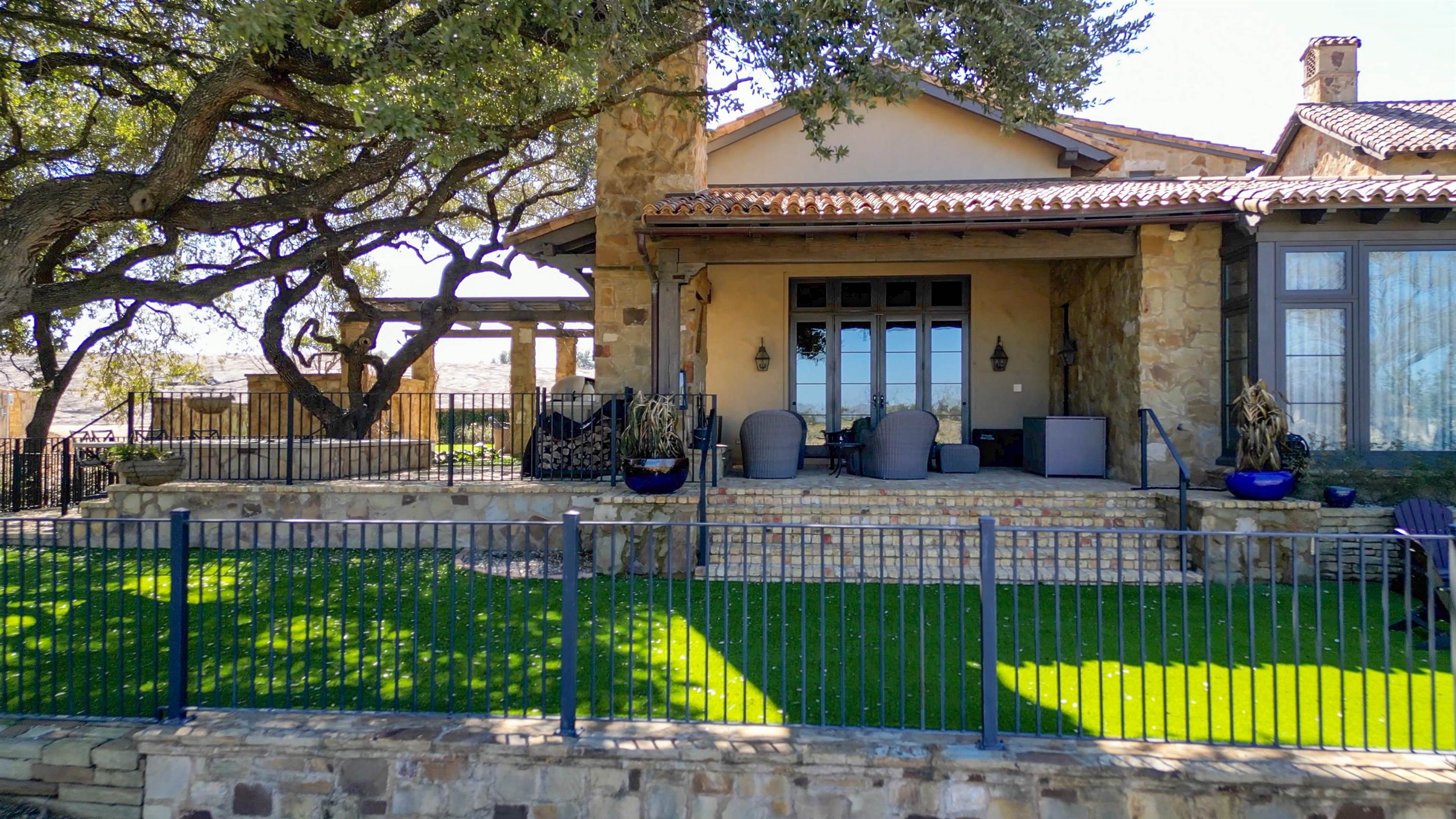 107 Bent Way Road Horseshoe Bay, TX 78657 - Photo 17 of 29 a view of a house with a patio and a garden