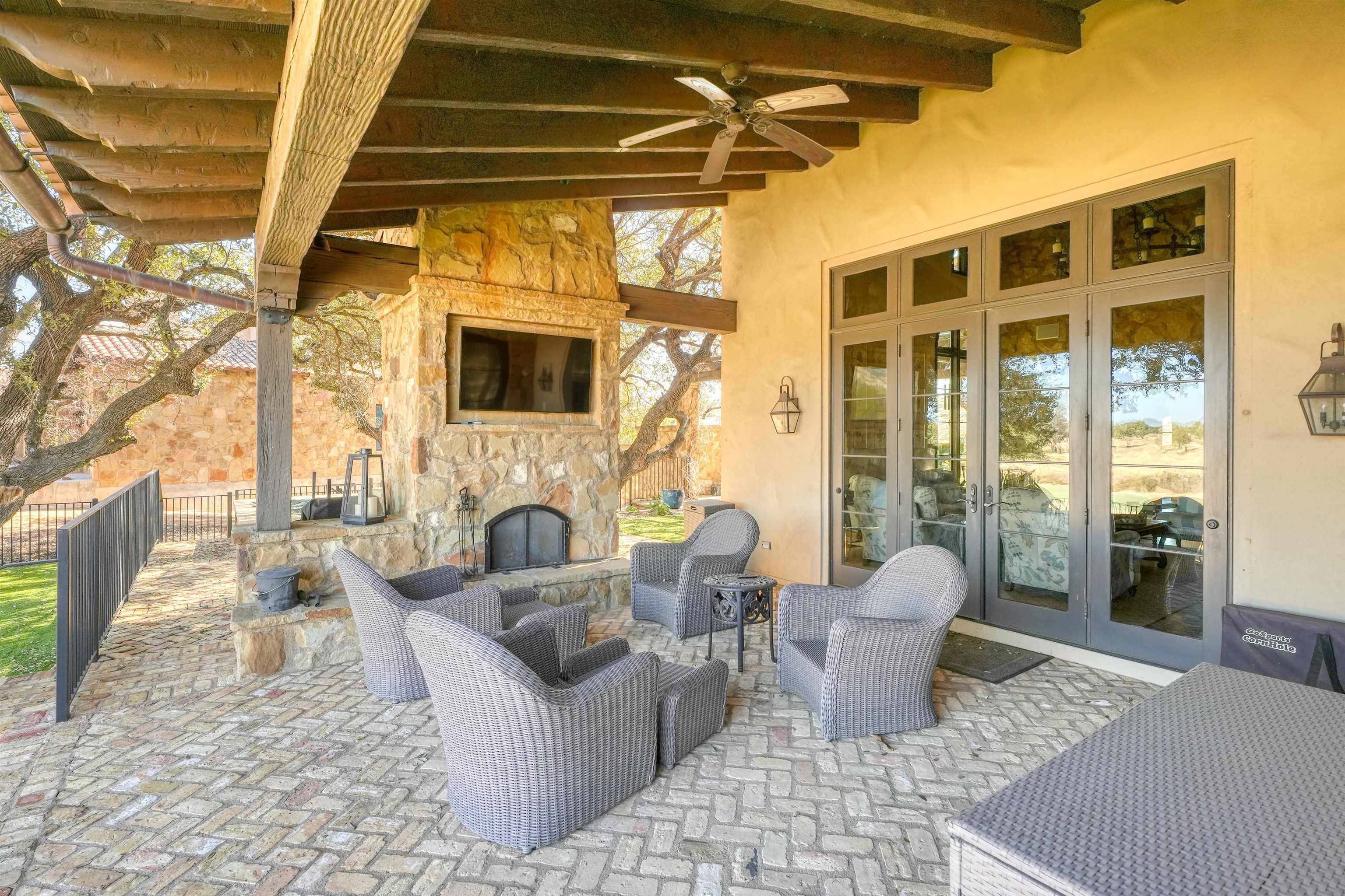 107 Bent Way Road Horseshoe Bay, TX 78657 - Photo 22 of 29 a living room with patio furniture and a fireplace
