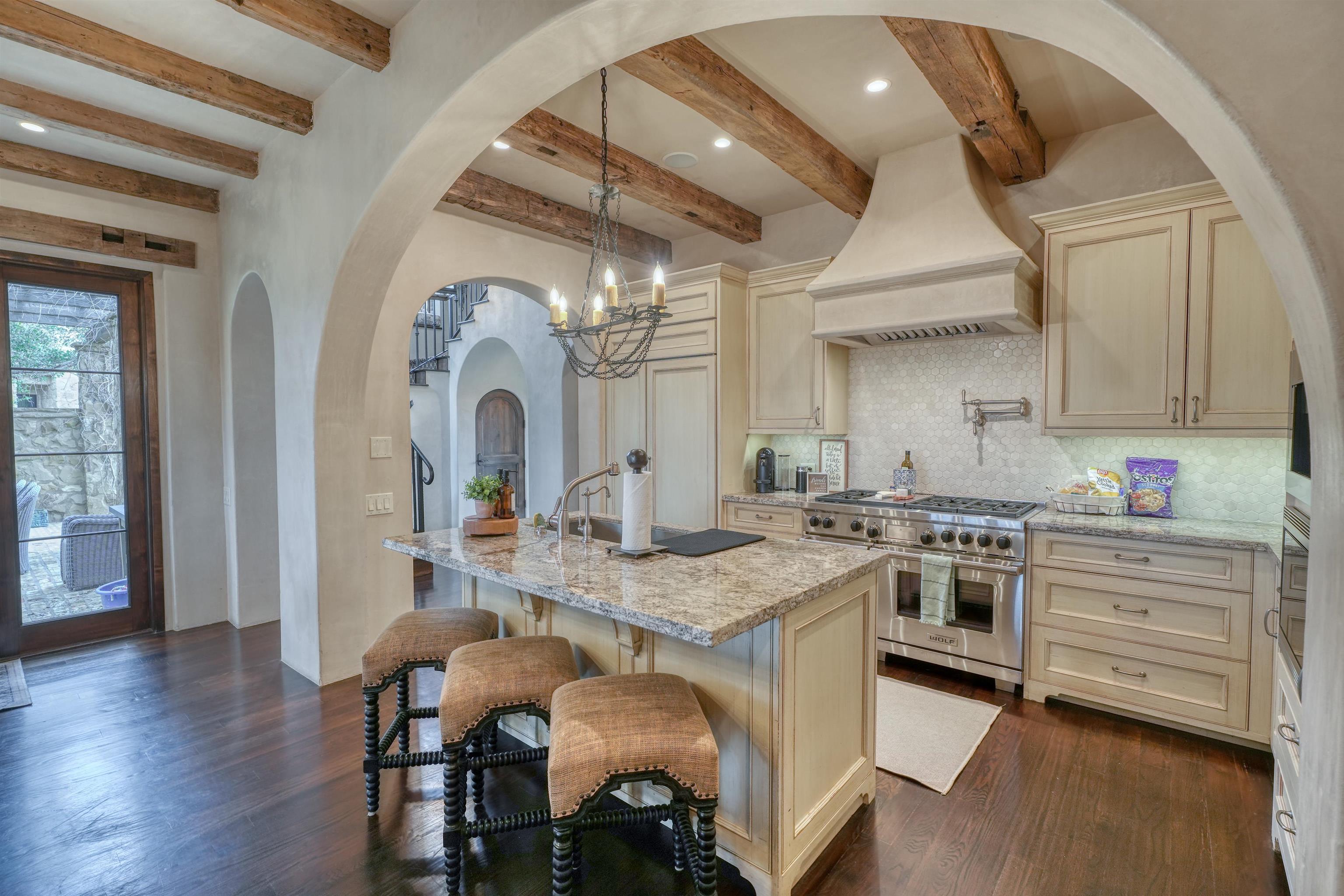 107 Bent Way Road Horseshoe Bay, TX 78657 - Photo 5 of 29 a open kitchen with granite countertop a stove a sink and chairs