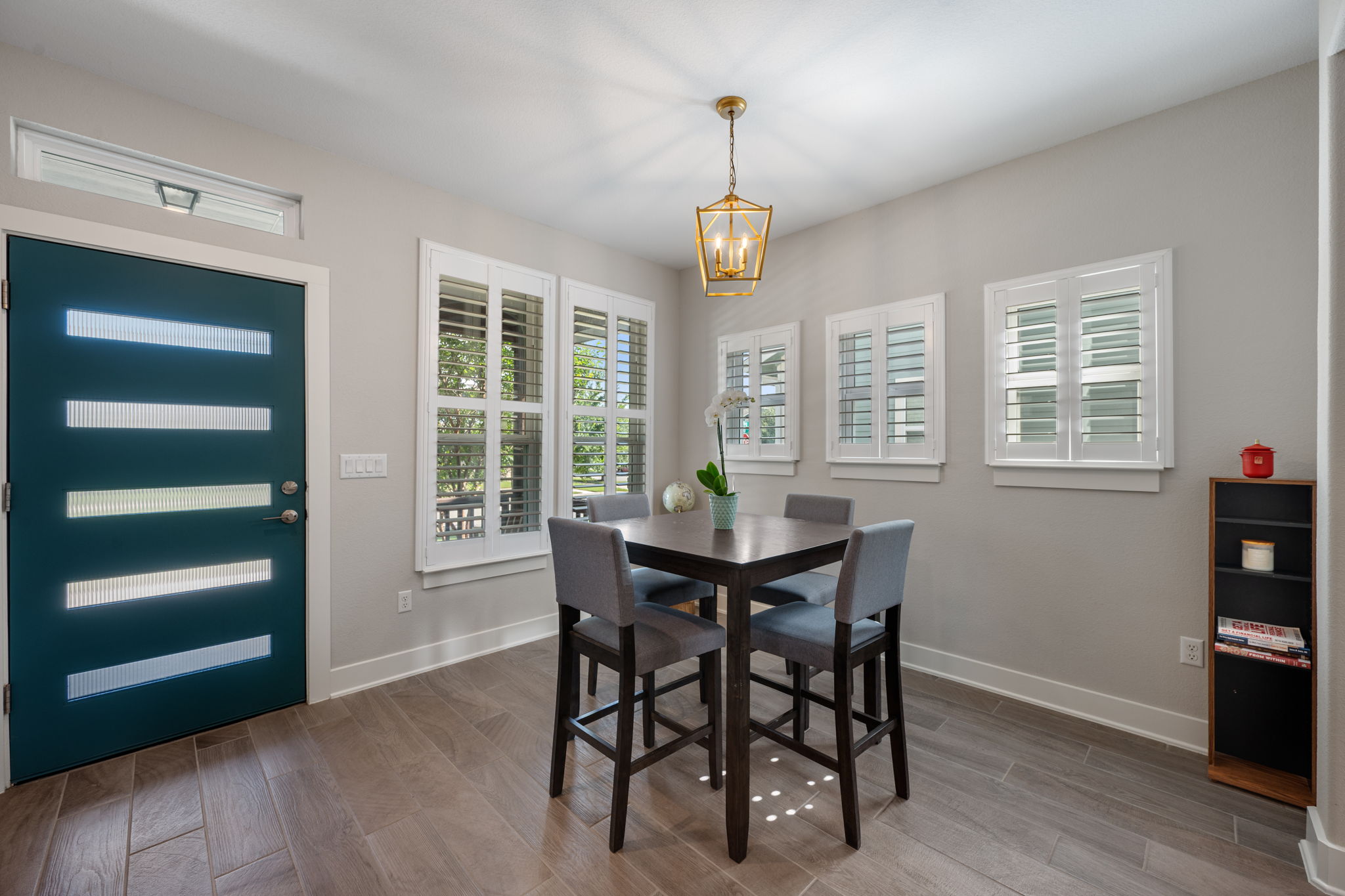 5409 Fox Wing Way Austin, TX 78747 - Photo 9 of 26 A welcoming entry area with a distinctive front door and natural light filtering through plantation-shuttered windows.