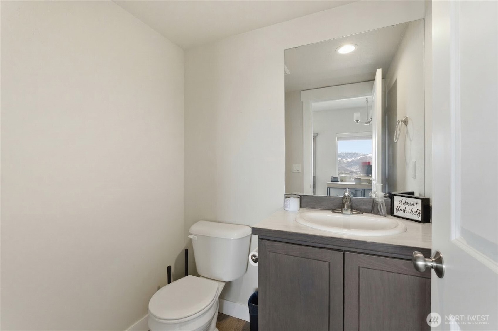 2247 S. Mystical Loop East Wenatchee, WA 98802 - Photo 17 of 25 a bathroom with a sink mirror vanity and toilet