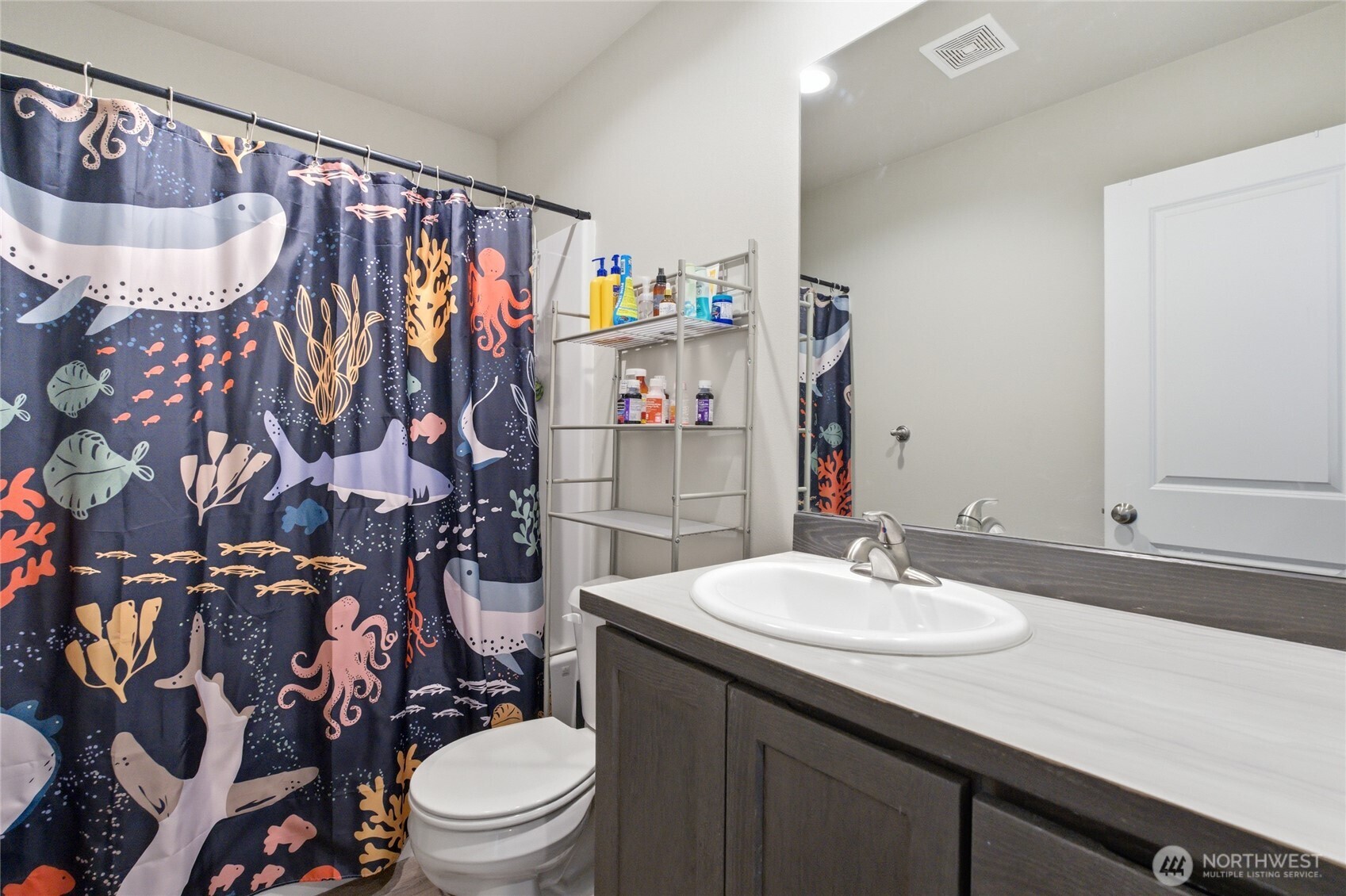 2247 S. Mystical Loop East Wenatchee, WA 98802 - Photo 19 of 25 a bathroom with a sink vanity mirror and toilet