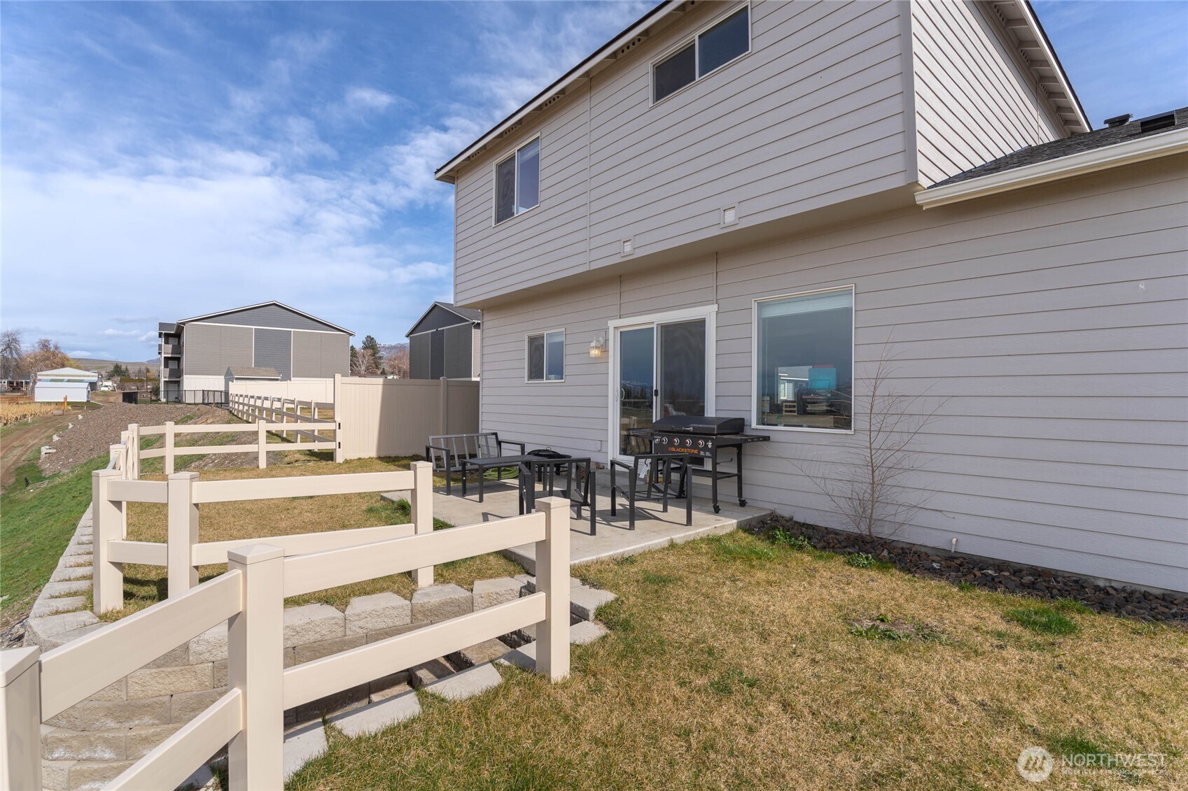 2247 S. Mystical Loop East Wenatchee, WA 98802 - Photo 21 of 25 a view of a patio with table and chairs and wooden floor