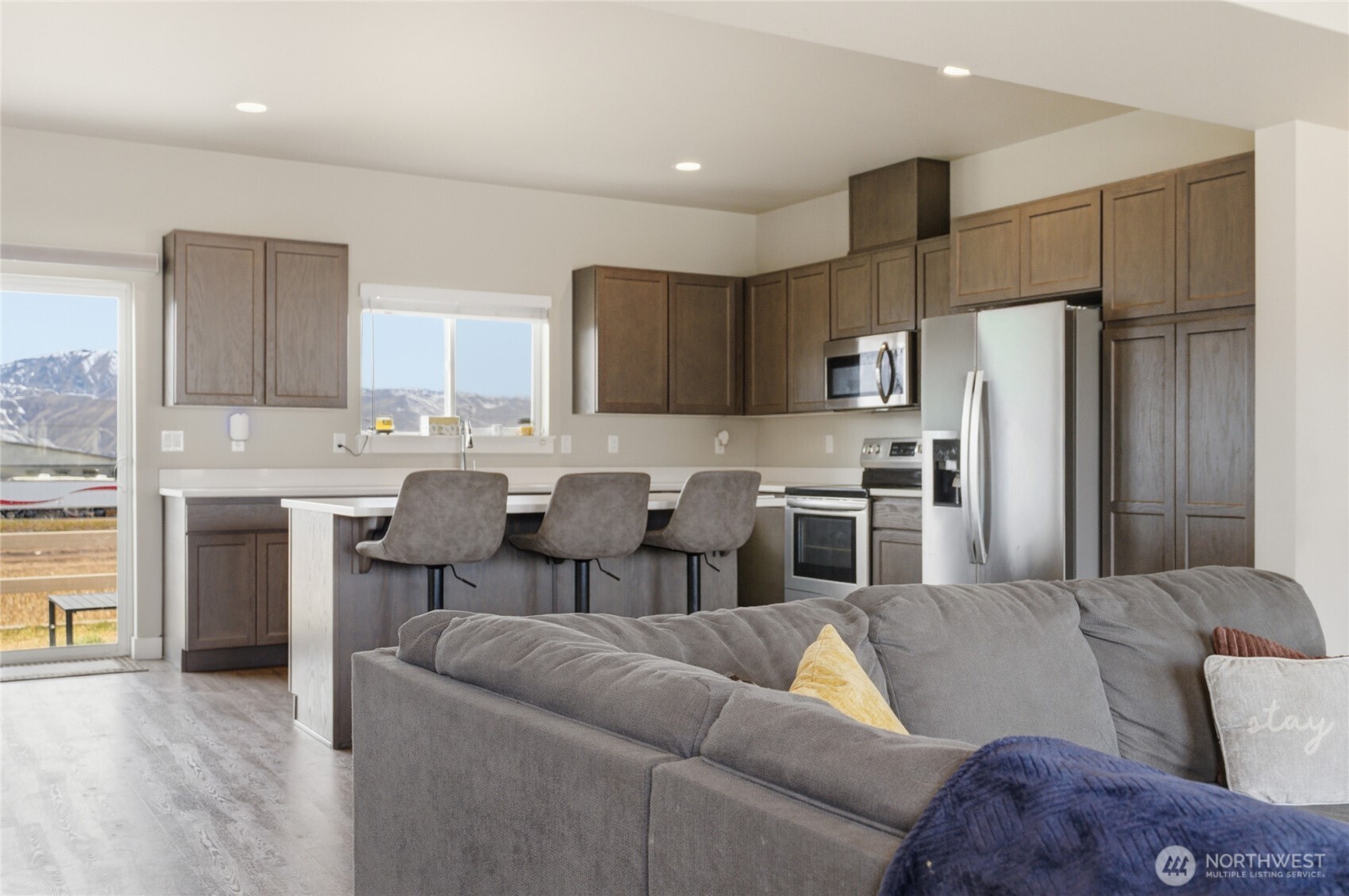 2247 S. Mystical Loop East Wenatchee, WA 98802 - Photo 3 of 25 a living room with stainless steel appliances kitchen island granite countertop furniture and a view of kitchen