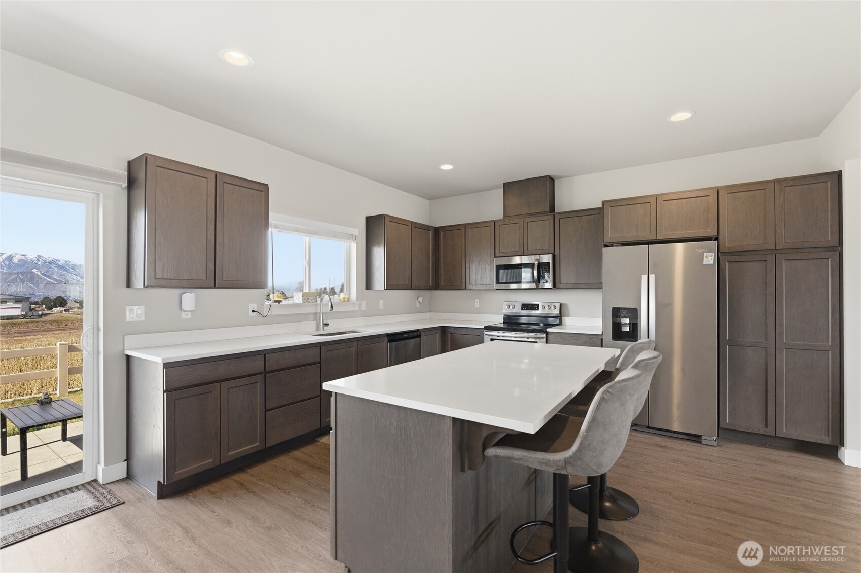 2247 S. Mystical Loop East Wenatchee, WA 98802 - Photo 4 of 25 a kitchen with a sink a counter top space stainless steel appliances and cabinets