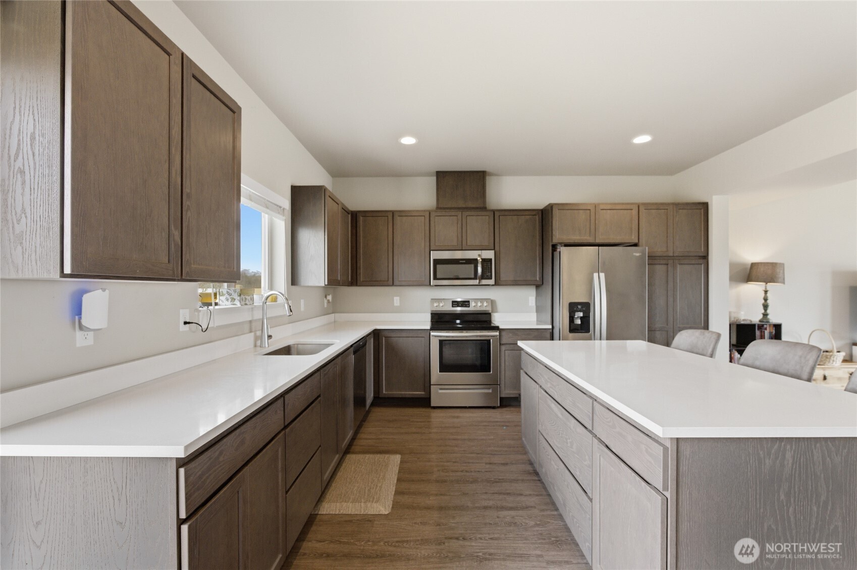 2247 S. Mystical Loop East Wenatchee, WA 98802 - Photo 5 of 25 a large kitchen with a large counter top a sink stainless steel appliances and cabinets