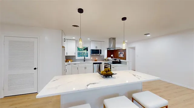 a kitchen with a sink a stove and a refrigerator