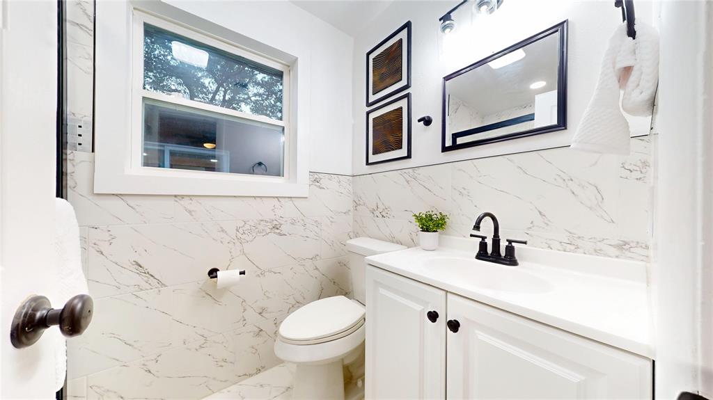 409 Vicki Place Hurst, TX 76053 - Photo 15 of 30 a bathroom with a toilet sink and mirror