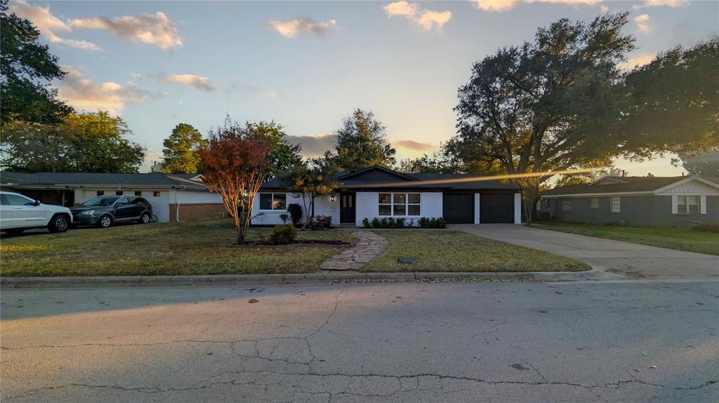 409 Vicki Place Hurst, TX 76053 - Photo 2 of 30 a front view of a house with a yard