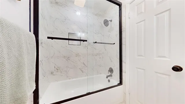 a bathroom with a bathtub and shower