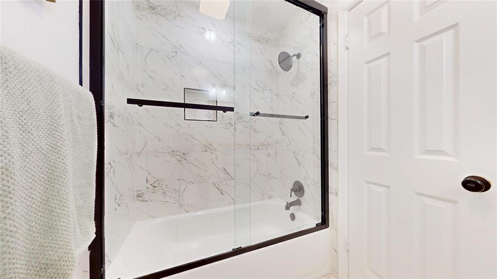 409 Vicki Place Hurst, TX 76053 - Photo 23 of 30 a bathroom with a bathtub and shower