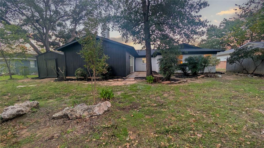 409 Vicki Place Hurst, TX 76053 - Photo 29 of 30 a backyard of a house with outdoor seating and tree