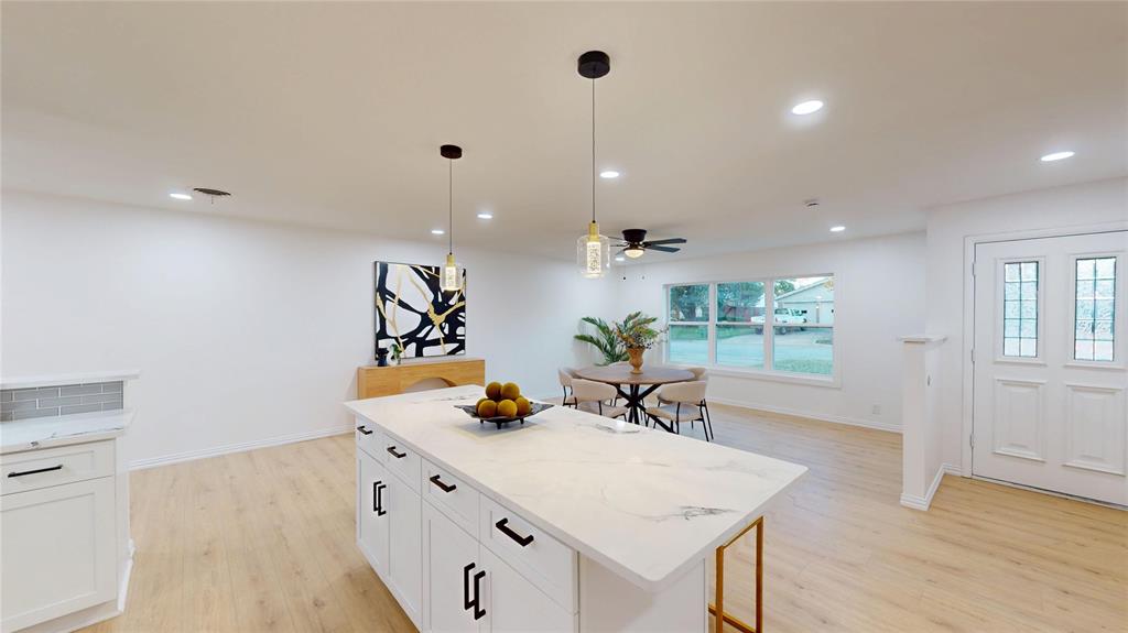 409 Vicki Place Hurst, TX 76053 - Photo 9 of 30 a view of a center island and living room