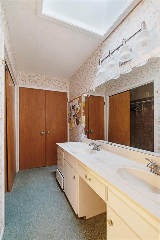 3345 West Kaufman Street Paris, TX 75460 - Photo 12 of 17 a bathroom with a sink and a mirror