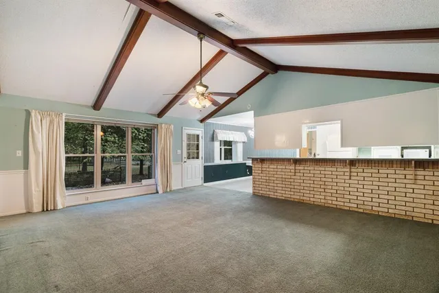 a view of an empty room with windows