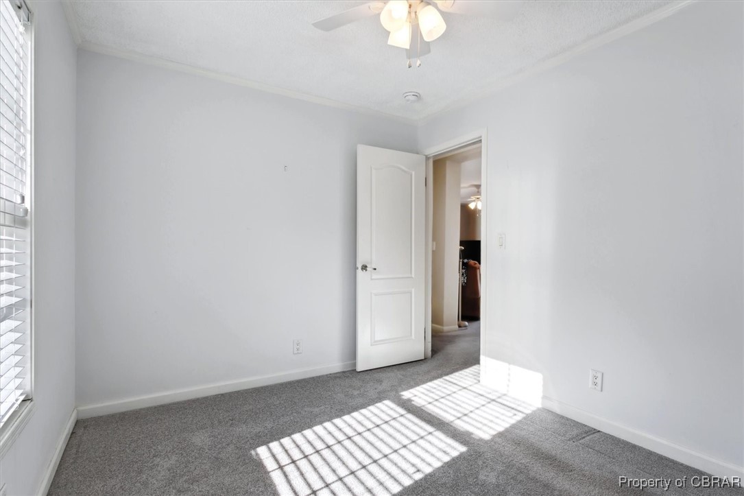 1413 Locust Grove Road Topping, VA 23169 - Photo 30 of 50 Spare room with ceiling fan and dark carpet