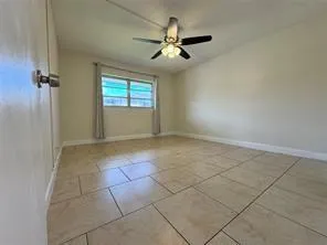 a view of a livingroom with a ceiling fan and window