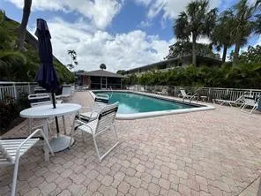 a view of a patio with a table and chairs