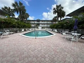a view of a swimming pool with outdoor seating