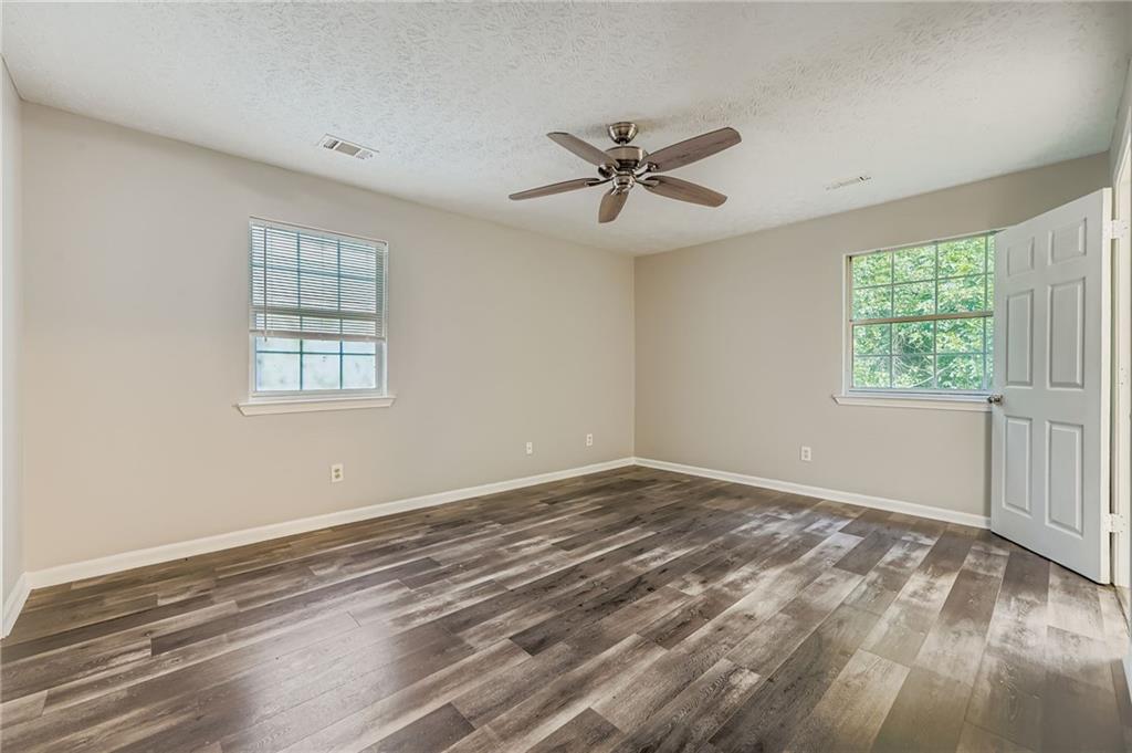 1607 Sweetgum Hill Decatur, GA 30032 - Photo 13 of 25 a view of a big room with wooden floor and windows in a room