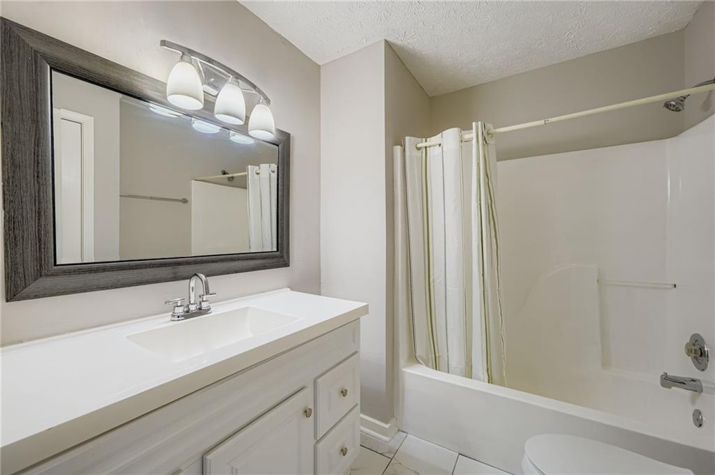 1607 Sweetgum Hill Decatur, GA 30032 - Photo 14 of 25 a bathroom with a double vanity sink mirror and shower