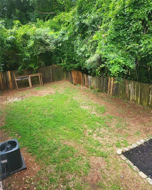 1607 Sweetgum Hill Decatur, GA 30032 - Photo 16 of 25 a backyard of a house with lots of green space
