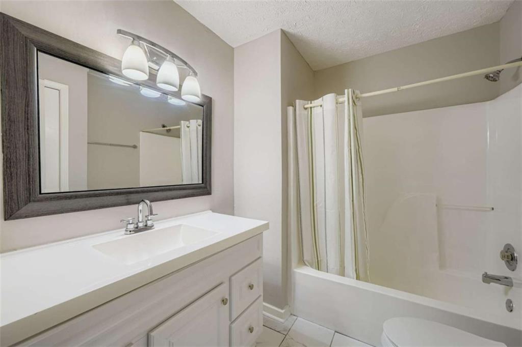 1607 Sweetgum Hill Decatur, GA 30032 - Photo 3 of 25 a bathroom with a double vanity sink mirror and shower