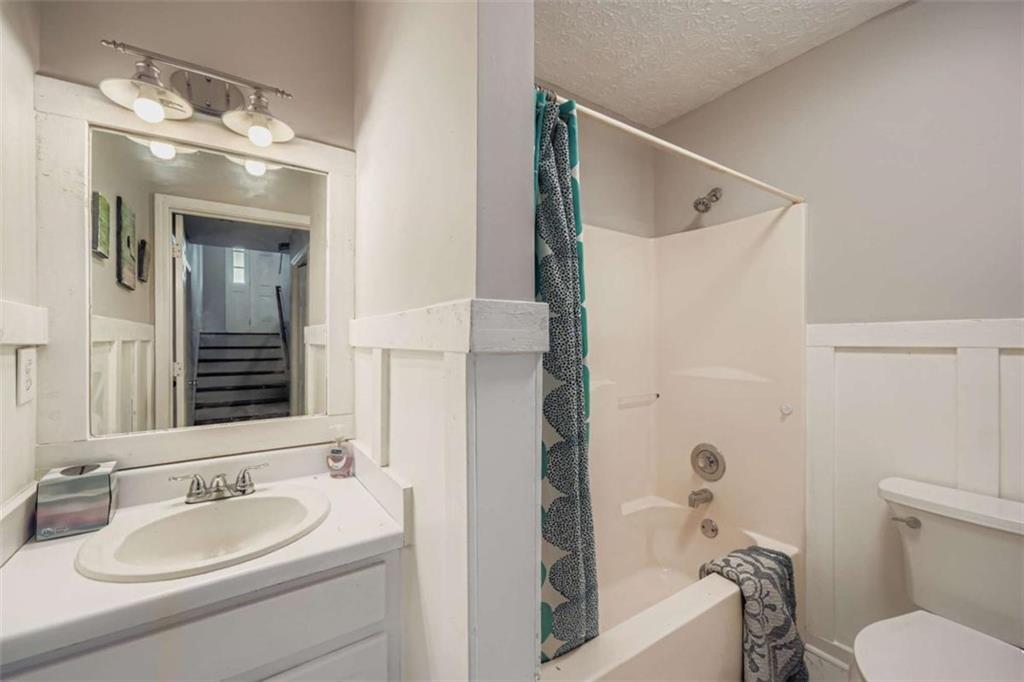 1607 Sweetgum Hill Decatur, GA 30032 - Photo 10 of 25 a bathroom with a granite countertop sink toilet and shower