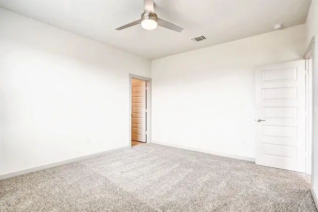 an empty room with a empty space and a ceiling fan