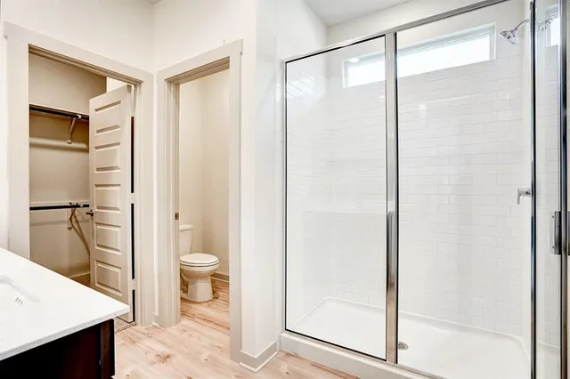 a bathroom with a shower and a toilet