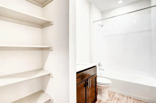 a white toilet sitting next to a shower curtain