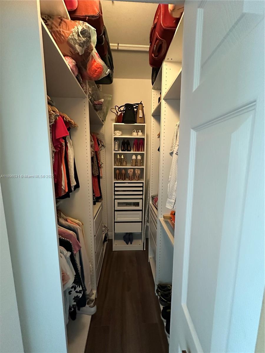 2662 Southwest 118 Road, Unit 2662 Miramar, FL 33025 - Photo 18 of 37 a view of walk in closet with clothes and shoes
