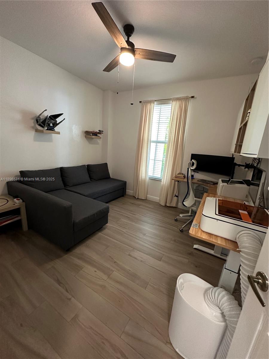 2662 Southwest 118 Road, Unit 2662 Miramar, FL 33025 - Photo 32 of 37 a living room with furniture and a wooden floor