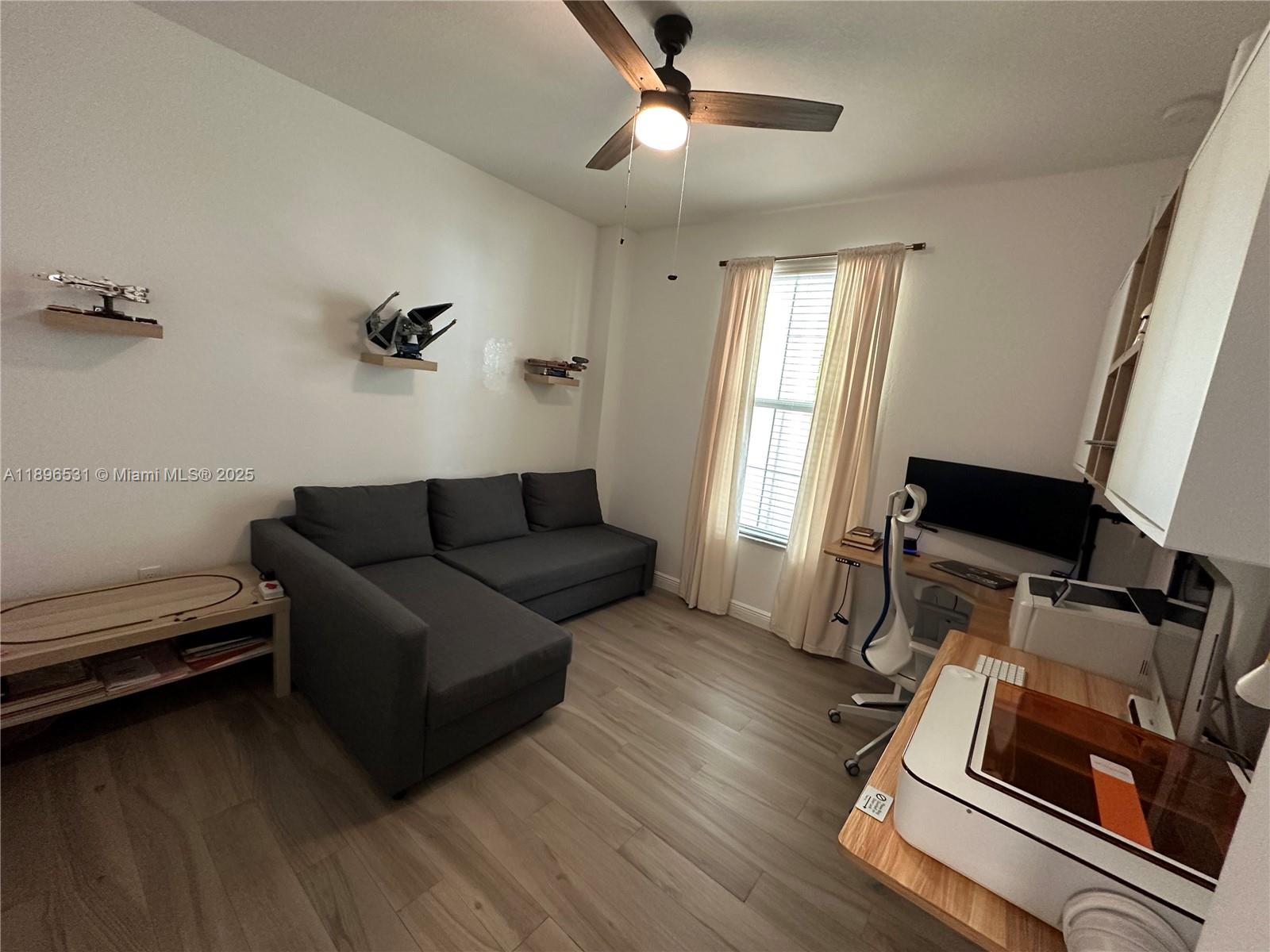 2662 Southwest 118 Road, Unit 2662 Miramar, FL 33025 - Photo 33 of 37 a living room with furniture and a window